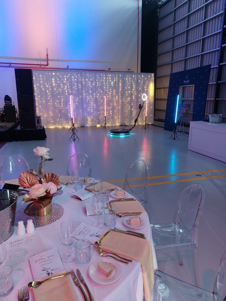 Memories Made and Personalised - Memories Made and Personalised - Reception Area with Fairy-light Backdrop, Ring Light, and a Small Photo Booth Platform in a Gym/warehouse Venue. -  - Photo Booth Hire | Packages & Pricing | Mmp Events -  - Photo Booth Hire | Packages & Pricing | Mmp Events